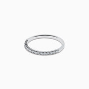 Displayed on a plain white background, the 14K White Gold Pave Diamond Band 0.14 TCW features a single row of small, sparkling diamonds set along the top half of its slim band.