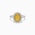The 18K Two Tone Gold White and GIA Certified Yellow Diamond Double Halo Ring features a central oval yellow diamond, surrounded by white diamonds and additional diamonds set along the band.