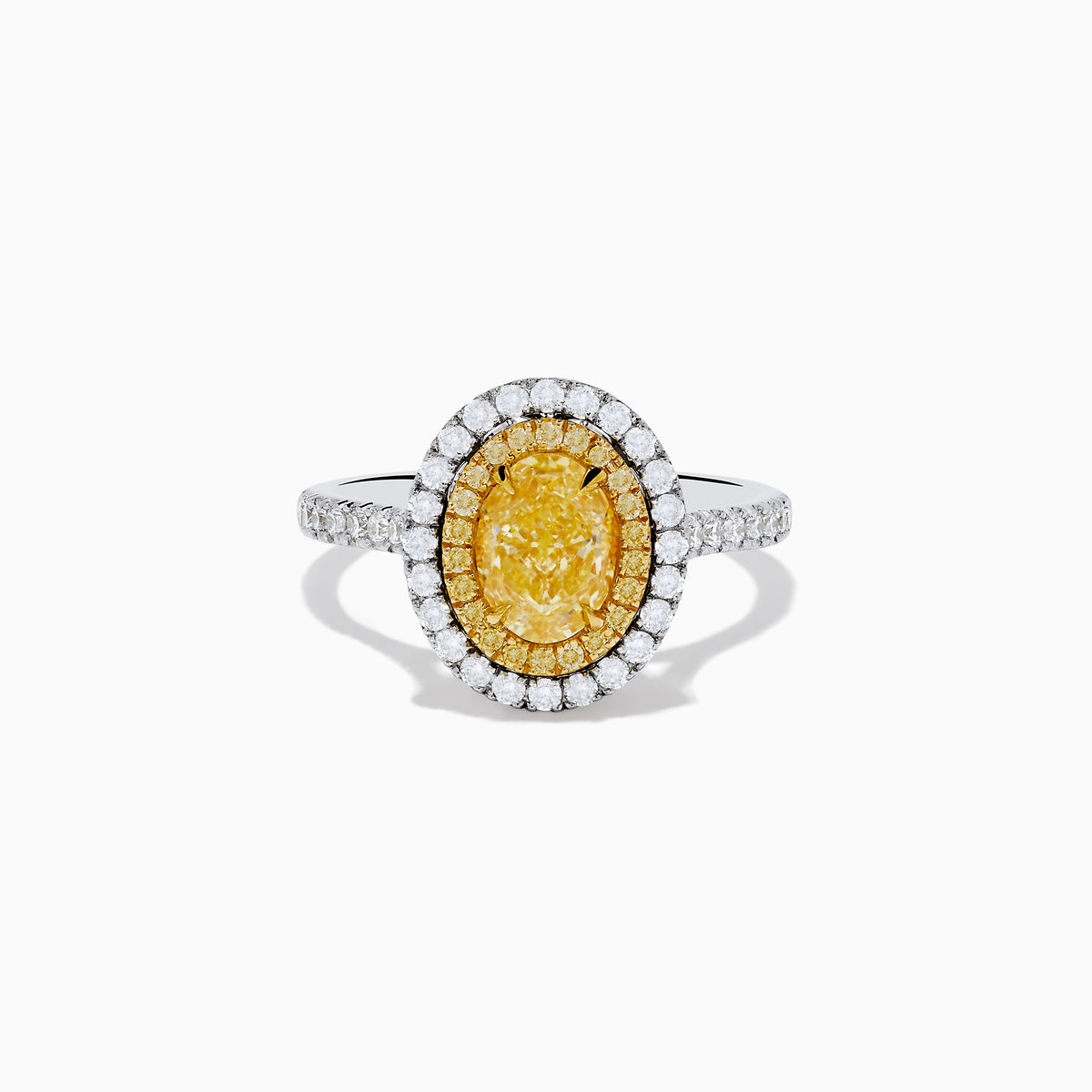 The 18K Two Tone Gold White and GIA Certified Yellow Diamond Double Halo Ring features a central oval yellow diamond, surrounded by white diamonds and additional diamonds set along the band.