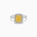 The 18K Two Toned Gold GIA certified Yellow and White Diamond Halo Ring features a rectangular yellow center stone, double halos of white diamonds, and extra diamonds along the band for exceptional brilliance.