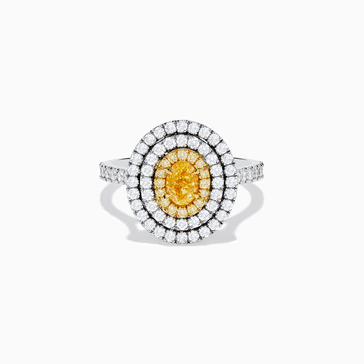 An 18K two-toned gold GIA certified Yellow and White Diamond Double Halo Ring, with an oval yellow center stone encircled by double halos of white diamonds on a diamond-accented band, displayed on a white background.