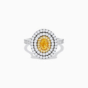 An 18K two-toned gold GIA certified Yellow and White Diamond Double Halo Ring, with an oval yellow center stone encircled by double halos of white diamonds on a diamond-accented band, displayed on a white background.