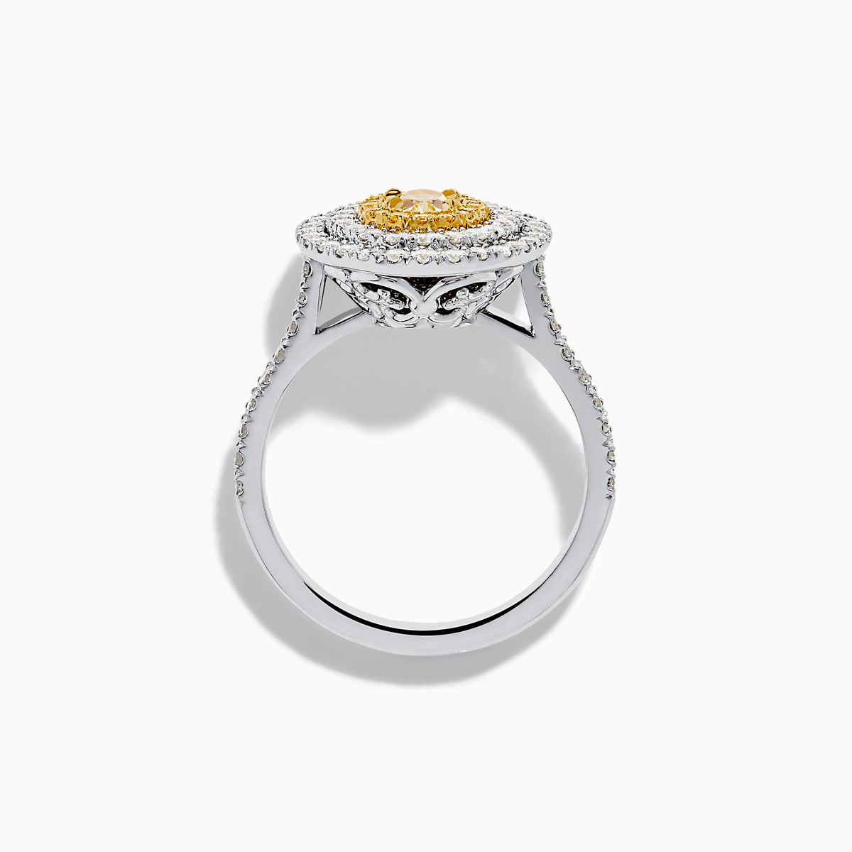 An 18K two-toned gold GIA certified Yellow and White Diamond Double Halo Ring, with an oval yellow center stone encircled by double halos of white diamonds on a diamond-accented band, displayed on a white background.