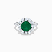 The 18K White Gold Emerald and Diamond Halo Ring features a large round green emerald center, surrounded by sparkling diamonds on the halo and band, beautifully displayed on a white background.