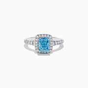 The 14K White Gold Lab Grown Blue and White Diamond Ring showcases a rectangular blue gemstone at its center, encircled by a halo of lab grown diamonds and more diamonds set along the band for extra sparkle.