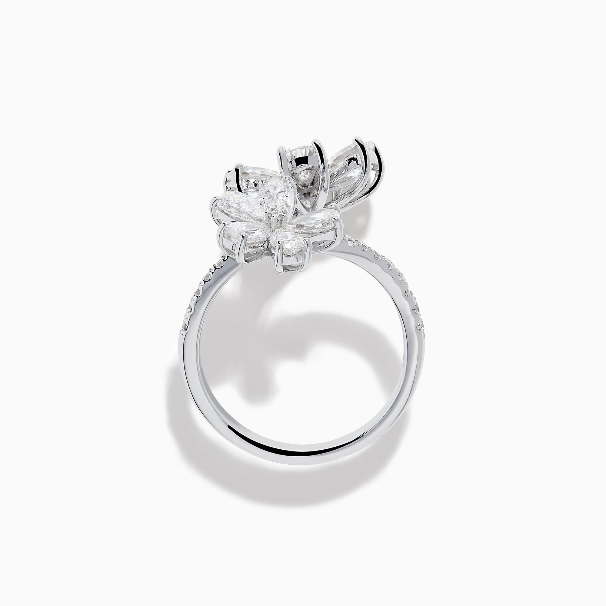The Lab Grown Pear and Round Diamond 2.75ct Flower Bypass Ring in 14K White Gold features two flower designs with pear-shaped and round diamonds on a partially encrusted band, set against a white background for an elegant look.