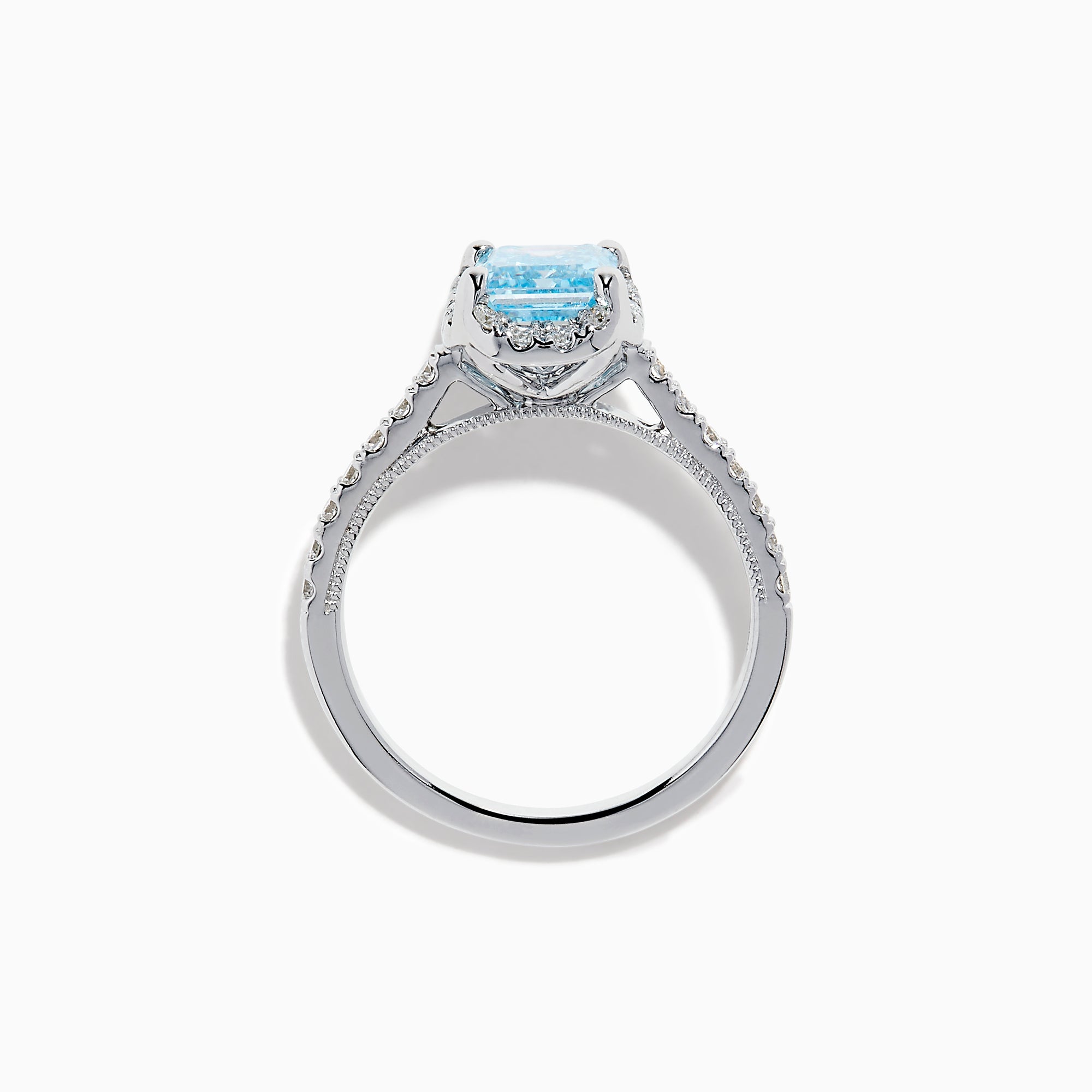 The Lab Grown Blue and White Diamond Halo Ring in 14K White Gold features an emerald-cut blue center stone with lab grown diamond accents, beautifully showcased on a white background.
