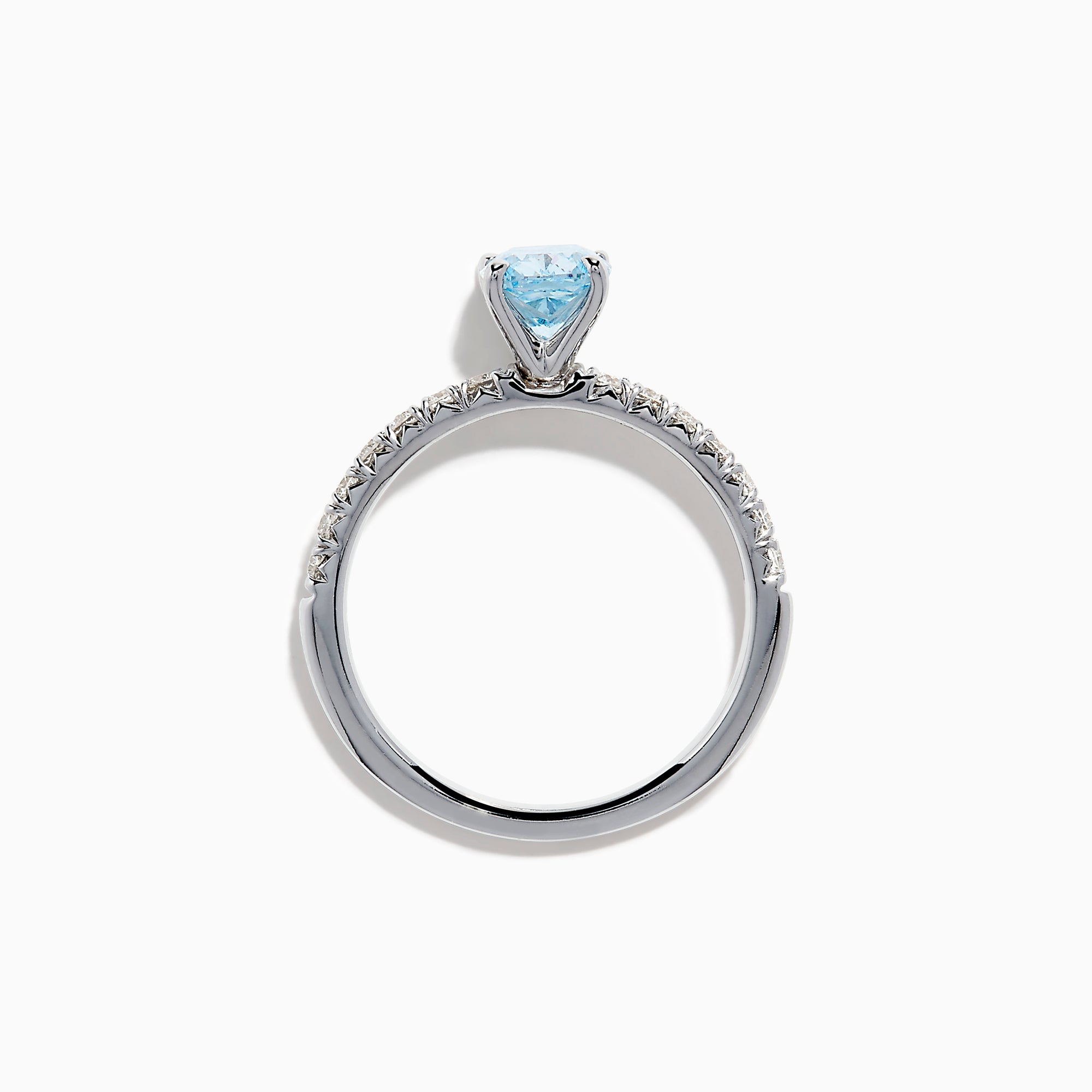 The Lab Grown Blue Diamond Solitaire Cushion Ring in 14K White Gold features a rectangular lab grown blue diamond at the center, accented with small clear round stones along the band.