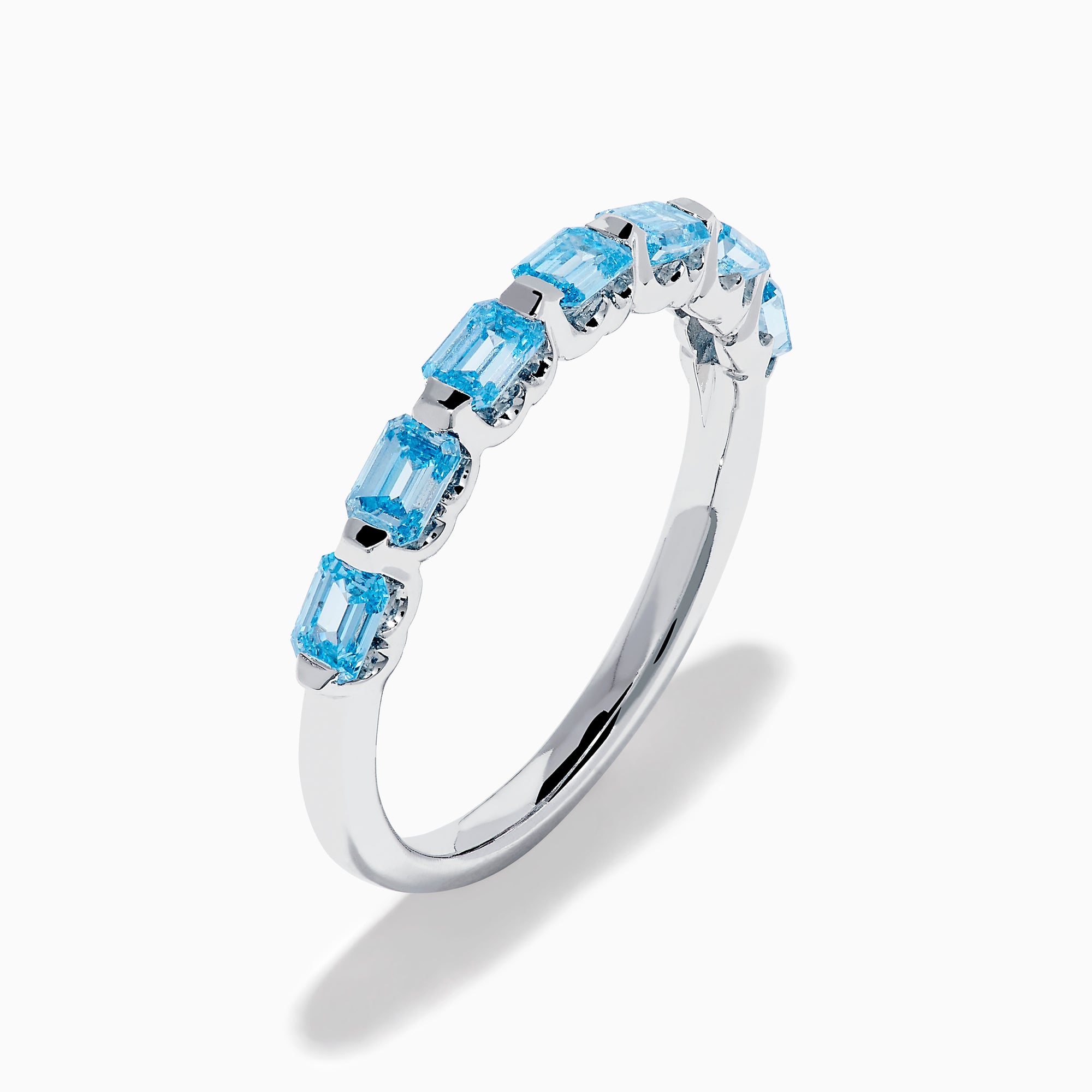 The Lab Grown Blue Diamond Emerald Cut Stacking Band in 14K White Gold features a row of emerald cut lab-grown blue diamonds set along the band, displayed on a plain white background.