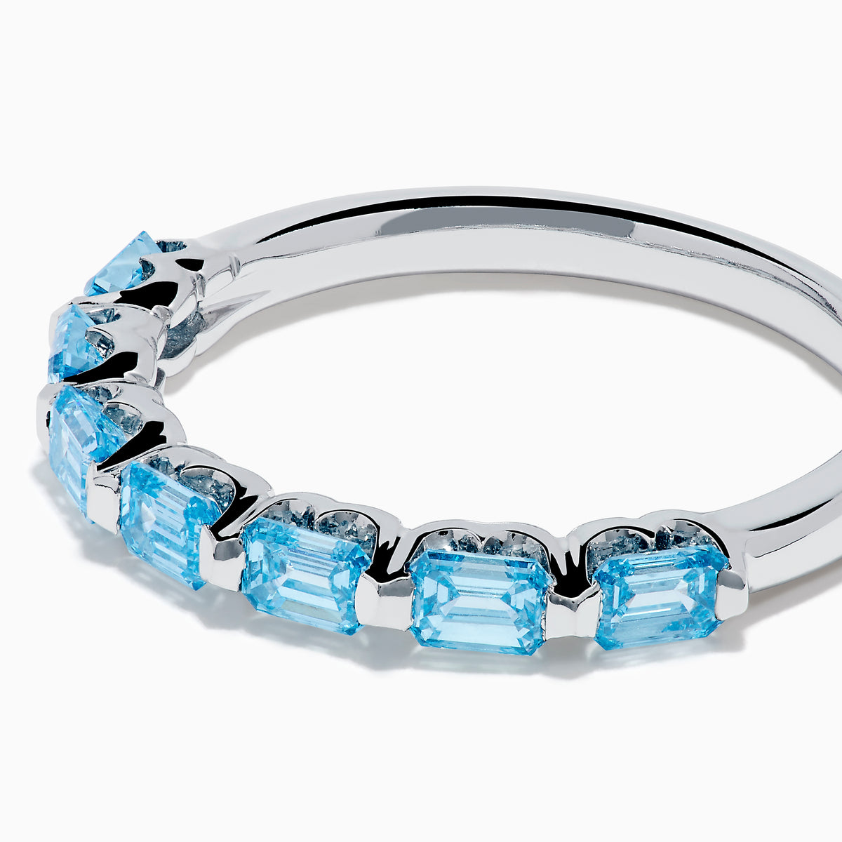 The Lab Grown Blue Diamond Emerald Cut Stacking Band in 14K White Gold features a row of emerald cut lab-grown blue diamonds set along the band, displayed on a plain white background.