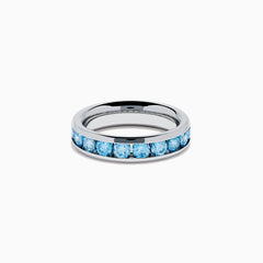 The Lab Grown Blue Diamond Channel Set Band in 14K White Gold features a row of round blue diamonds encircling the band, shown elegantly on a plain white background.