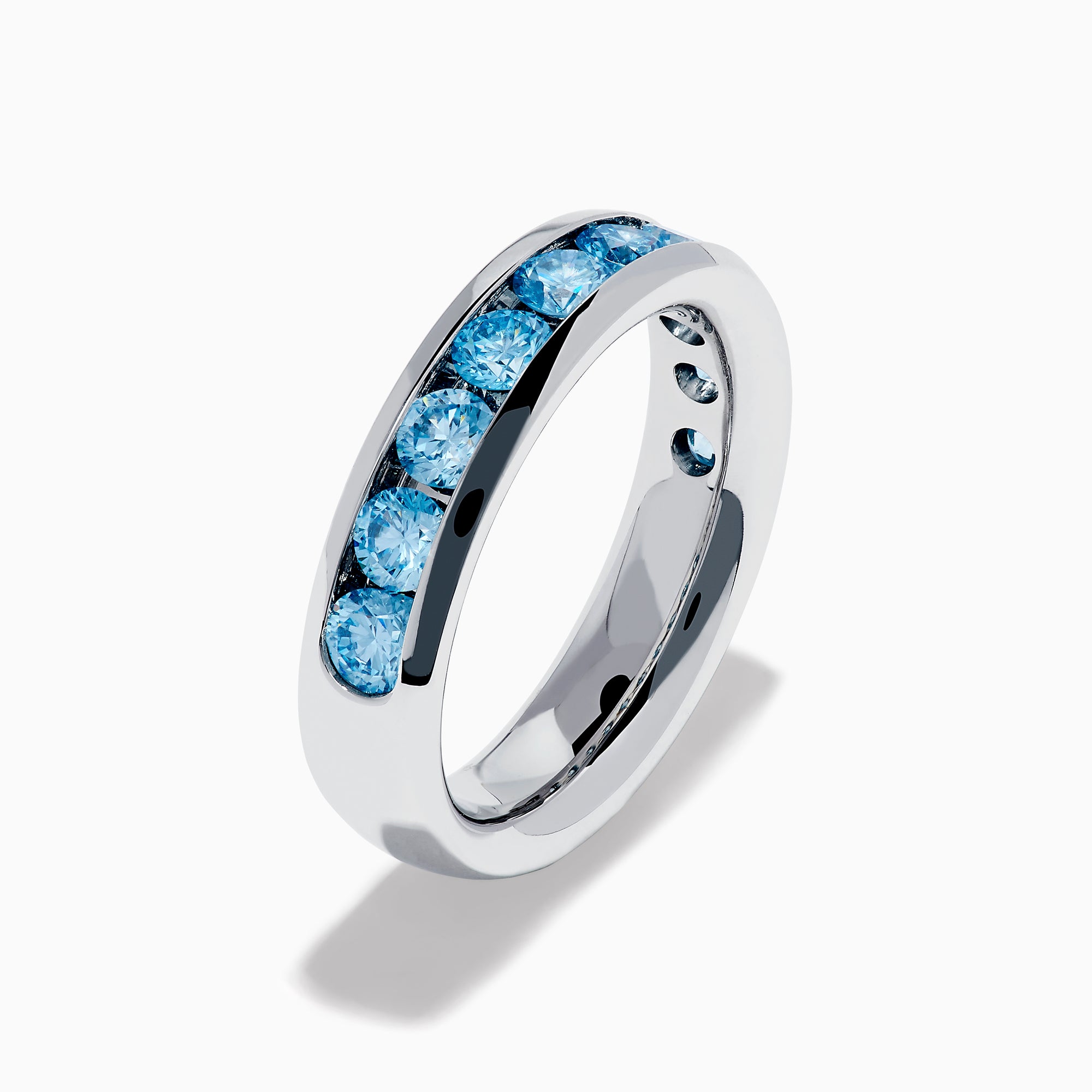 The Lab Grown Blue Diamond Channel Set Band in 14K White Gold features a row of round blue diamonds encircling the band, shown elegantly on a plain white background.
