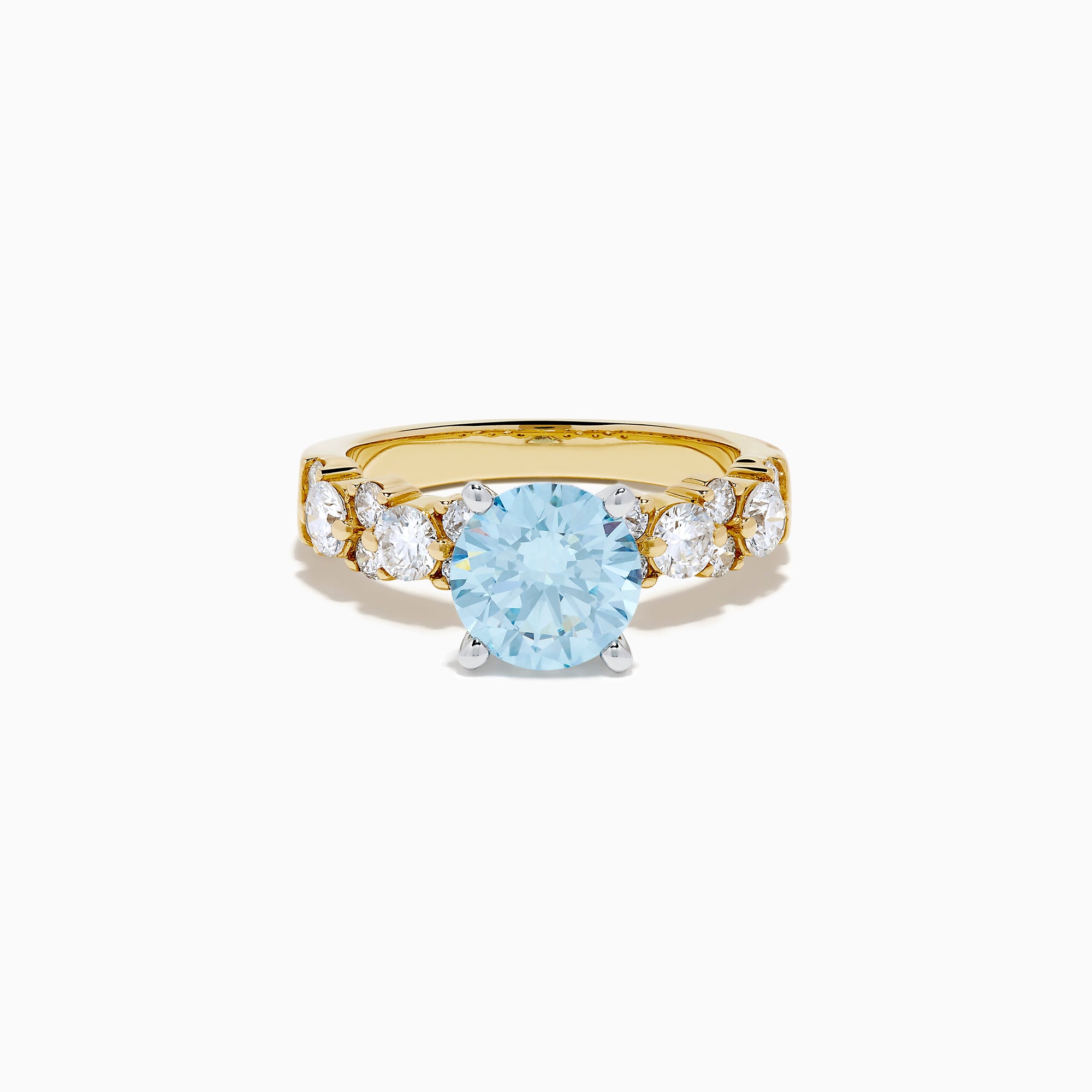 The Lab Grown Blue and White Diamond Ring in 14K Yellow Gold showcases a large round light blue gemstone at the center, accented by three teardrop-shaped lab grown white diamonds on each side.
