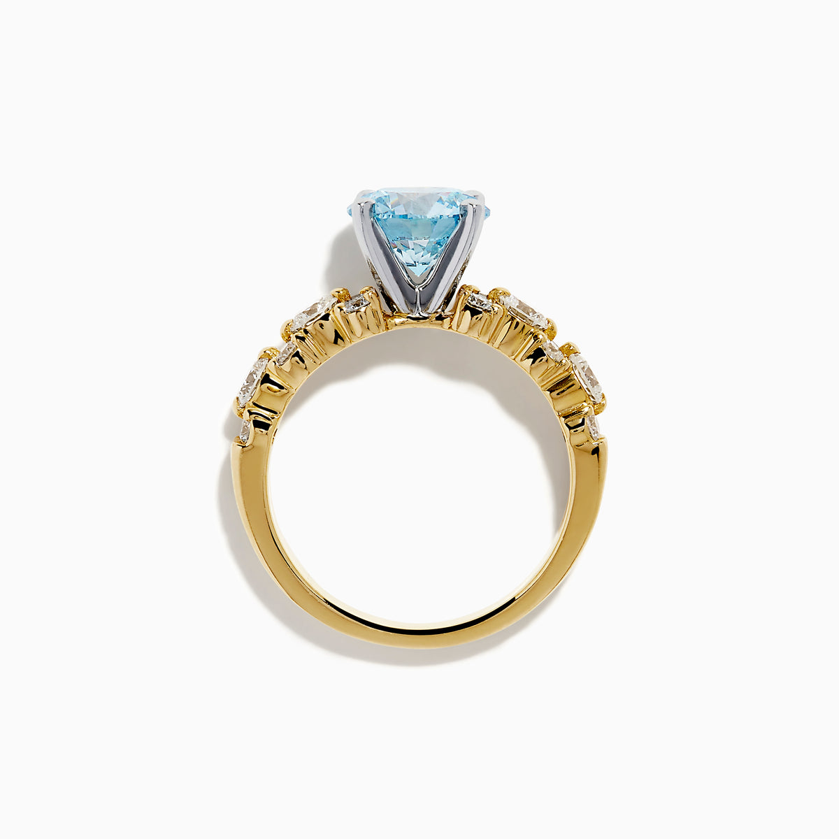 The Lab Grown Blue and White Diamond Ring in 14K Yellow Gold showcases a large round light blue gemstone at the center, accented by three teardrop-shaped lab grown white diamonds on each side.