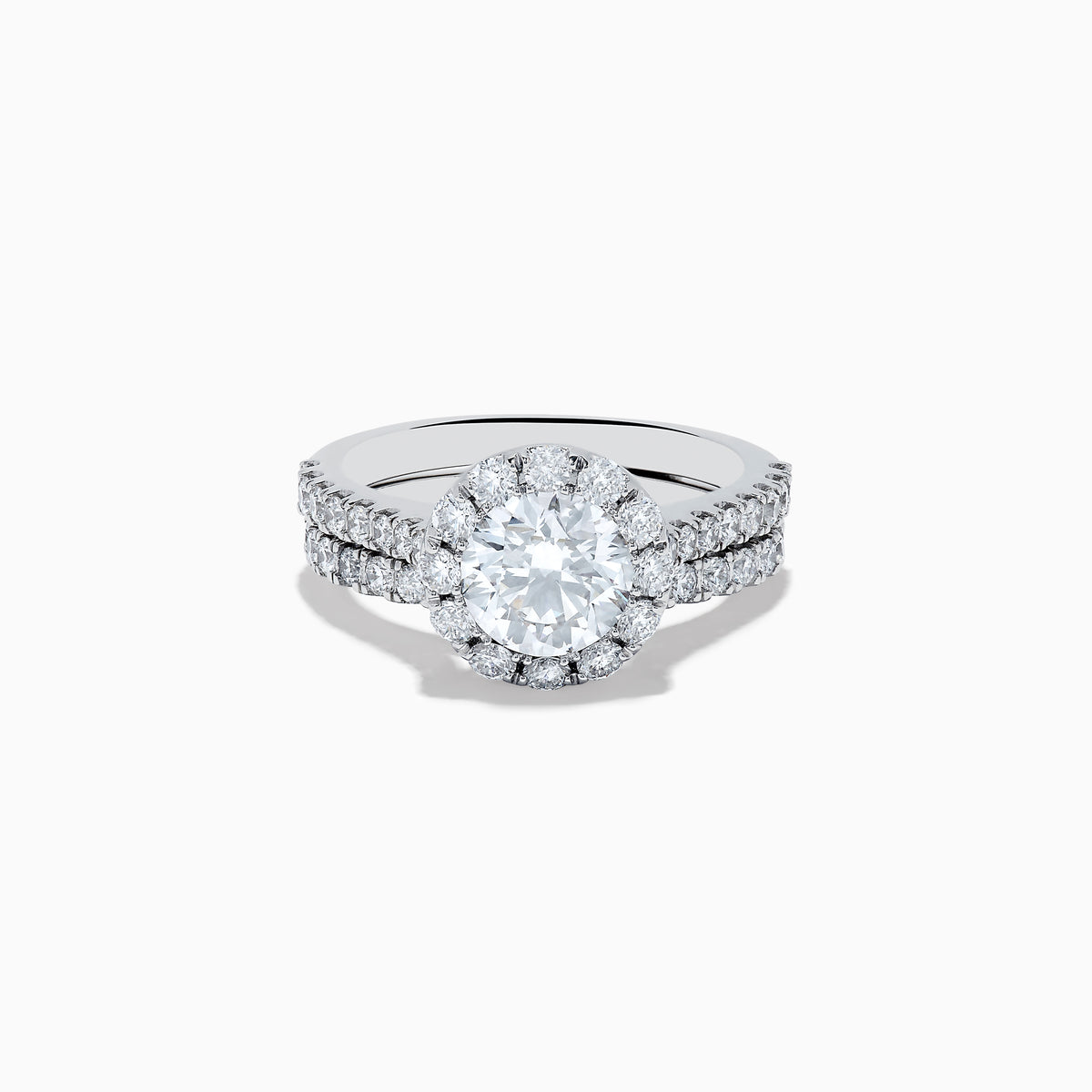 The 14K White Gold Lab Grown Diamond Ring and Band Set features a large round lab grown diamond, surrounded by smaller diamonds on a split shank band encrusted with more diamonds, all shown against a white background.