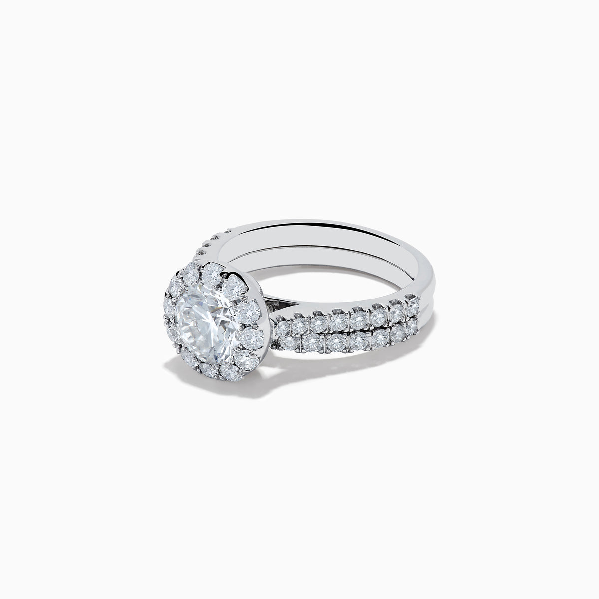 The 14K White Gold Lab Grown Diamond Ring and Band Set features a large round lab grown diamond, surrounded by smaller diamonds on a split shank band encrusted with more diamonds, all shown against a white background.