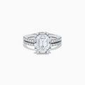 The 14K White Gold Lab Grown Diamond Ring and Band Set features a striking emerald-cut center diamond with round diamonds along the split shank band, shown on a plain white background.