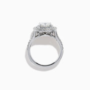 The Lab Grown Cushion Diamond Double Halo Ring in 14K White Gold features a cushion-cut center diamond, double halo of smaller diamonds, and additional diamonds along the band.