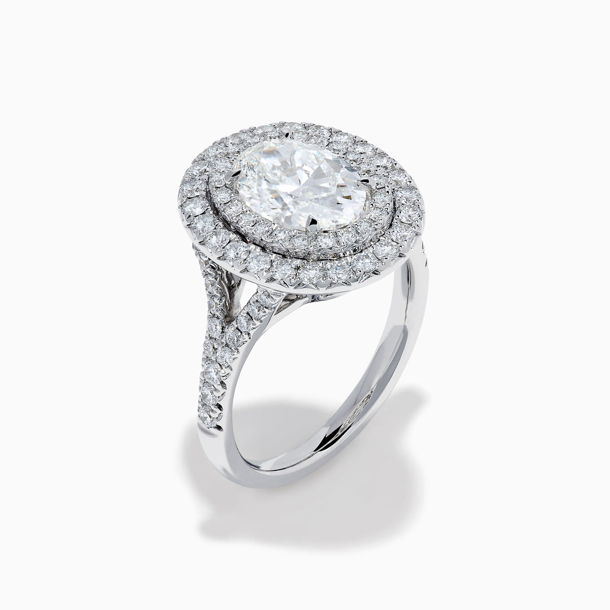 The Lab Grown Oval Diamond Double Halo Ring in 14K White Gold features a dazzling oval center, lab grown diamonds in a double halo, and extra sparkle along the band for an elegant look.