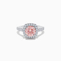 The 14K White Gold Lab Grown Pink and White Diamond Ring features a large oval pink center stone, a halo of lab grown diamonds, and additional diamonds on the band, displayed against a white background.