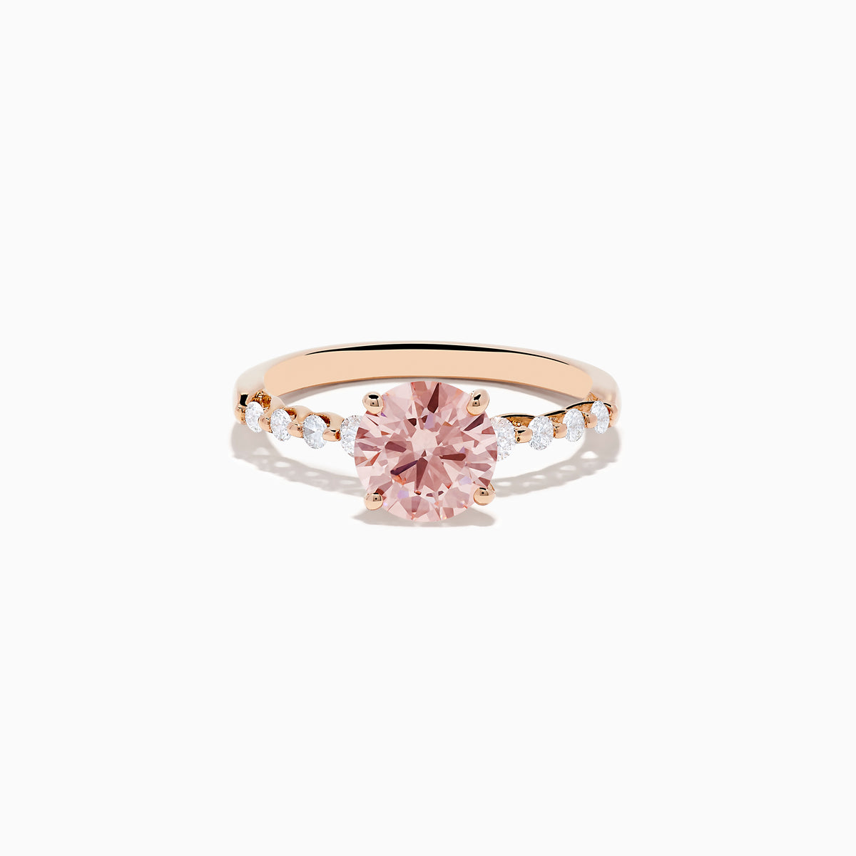 The 14K Rose Gold Lab Grown Pink and White Diamond Ring showcases a large round pink and white diamond centered between three smaller clear stones on each side, set against a plain white background.