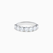 The Lab Grown Diamond Wedding Band in 14K White Gold showcases round, sparkling lab diamonds in a shared-prong setting on a sleek band, set against a white background.