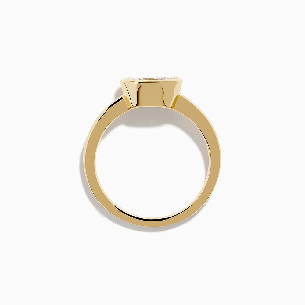 The Lab Grown Diamond East West Oval Ring in 14K Yellow Gold showcases a single lab diamond in a sleek bezel setting, presented against a plain white background.