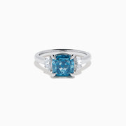 Lab Grown Blue and White Diamond 3-Stone Ring in 14K White Gold, featuring a prominent cushion-cut blue and white diamond center with two clear triangular side stones, shown on a white background.