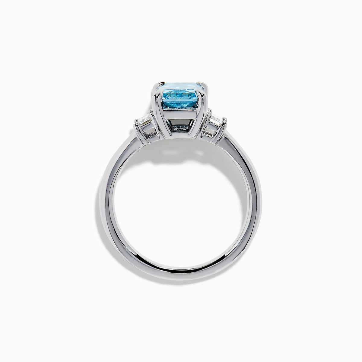 The Lab Grown Blue Diamond 3-Stone Ring in 14K White Gold features a brilliant blue center diamond with two clear rectangular side stones, set in sleek white gold against a crisp white background.