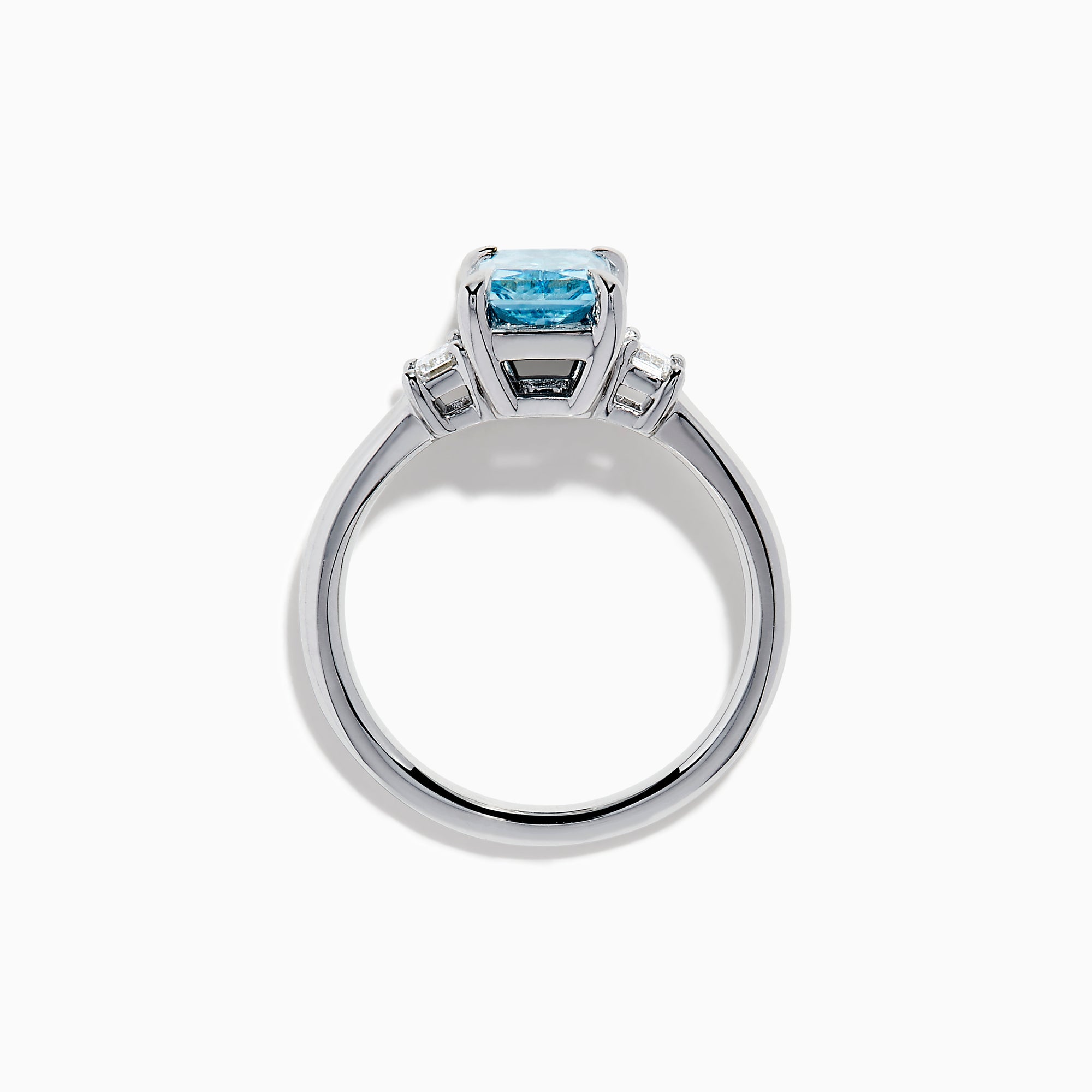 The Lab Grown Blue Diamond 3-Stone Ring in 14K White Gold features a brilliant blue center diamond with two clear rectangular side stones, set in sleek white gold against a crisp white background.
