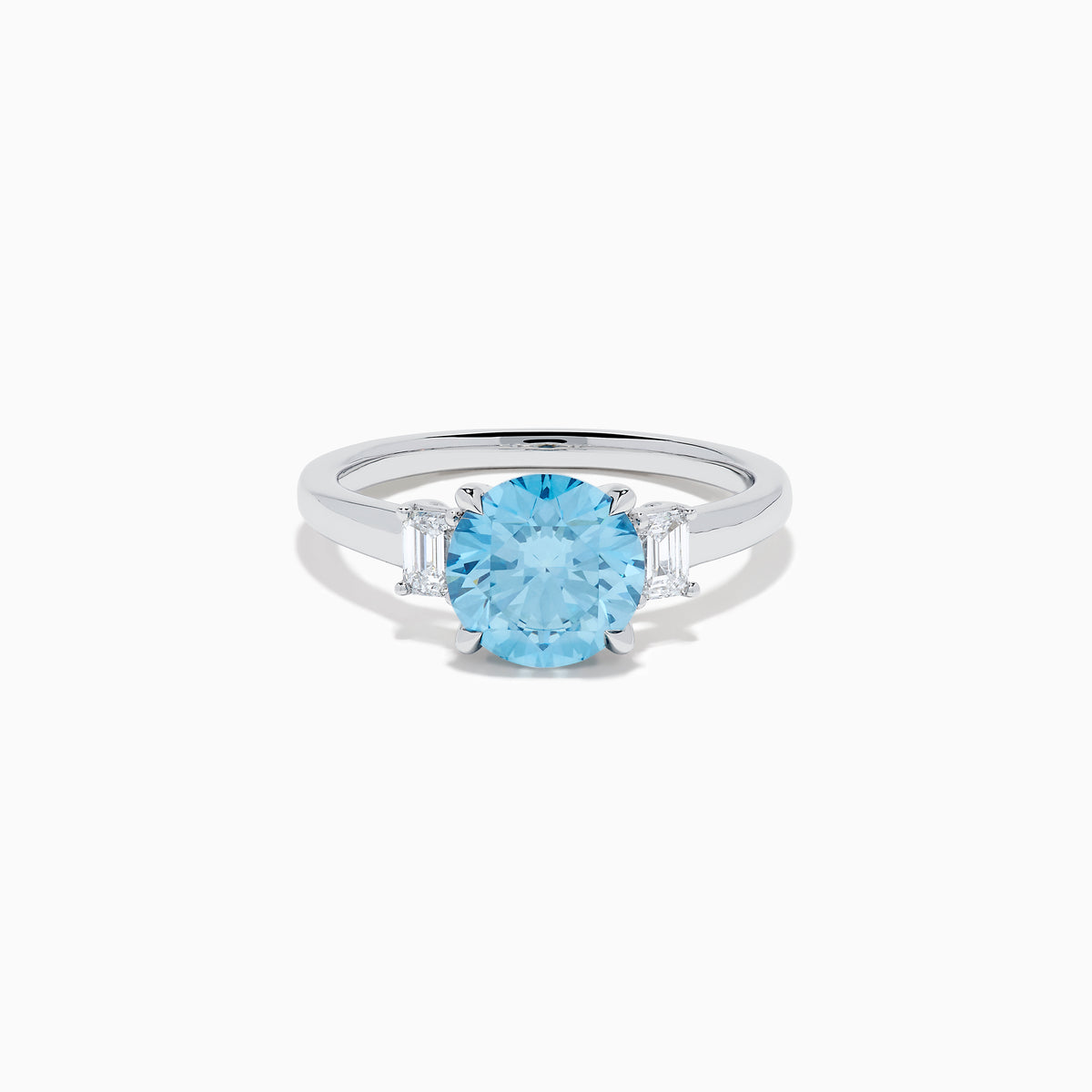 The Lab Grown Blue and White Diamond 3 Stone Ring in 14K White Gold features a striking round blue gemstone center with two rectangular lab grown diamonds on each side, all set in elegant white gold.