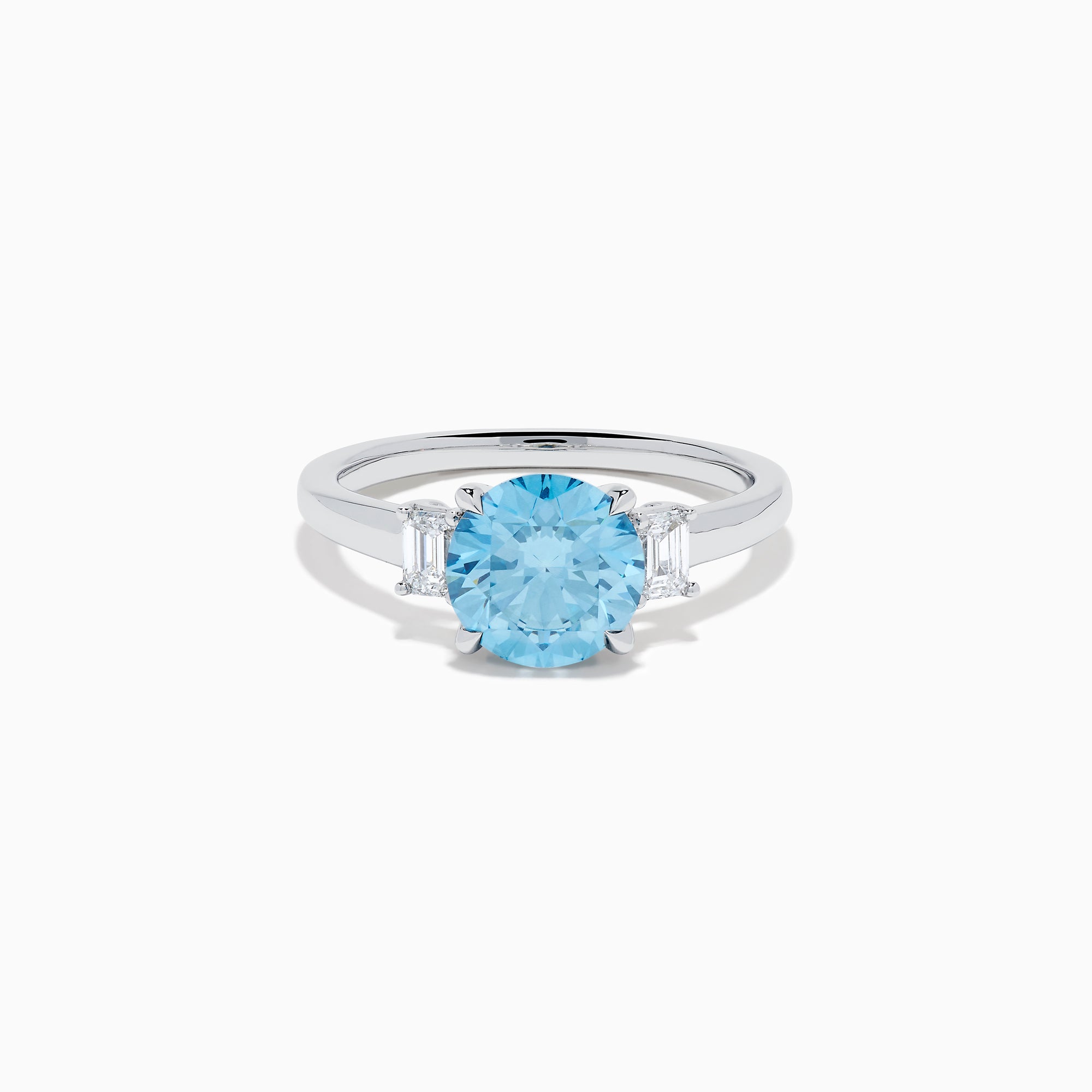 The Lab Grown Blue and White Diamond 3 Stone Ring in 14K White Gold features a striking round blue gemstone center with two rectangular lab grown diamonds on each side, all set in elegant white gold.
