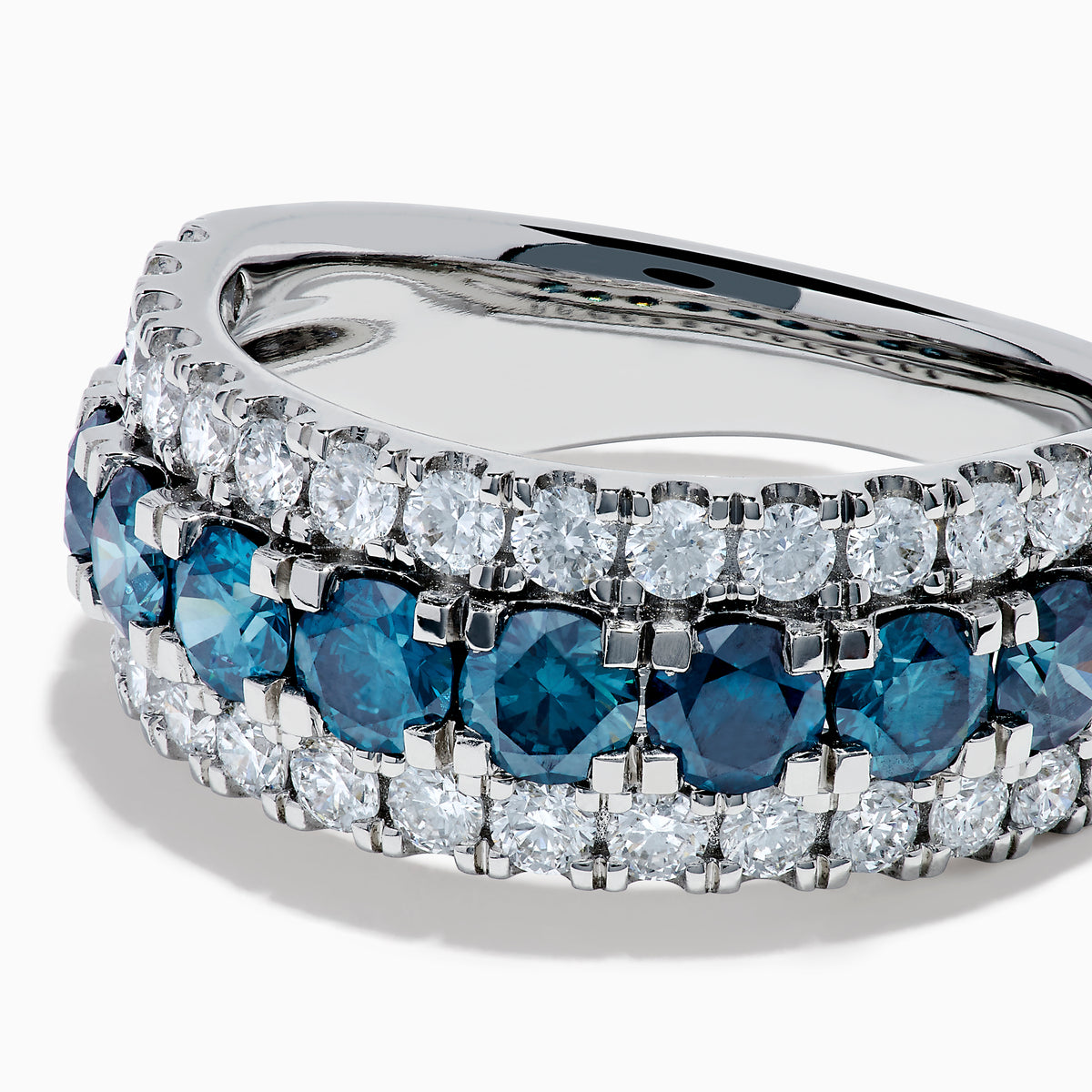 The Lab Grown Blue and White Diamond Wide Band Ring in 14K White Gold showcases a central row of blue stones flanked by lab grown diamonds in a striking triple-band design.