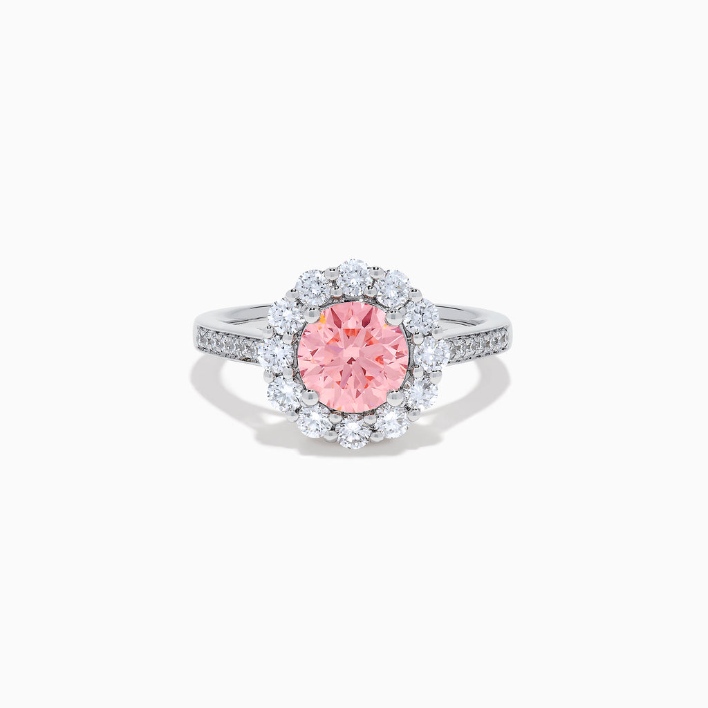 The Lab Grown Pink and White Diamond Halo Ring in 14K White Gold features a round pink gemstone center, surrounded by a halo of lab grown diamonds and additional diamonds along the elegant band.