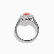 The Lab Grown Pink and White Diamond Halo Ring in 14K White Gold features a round pink gemstone center, surrounded by a halo of lab grown diamonds and additional diamonds along the elegant band.