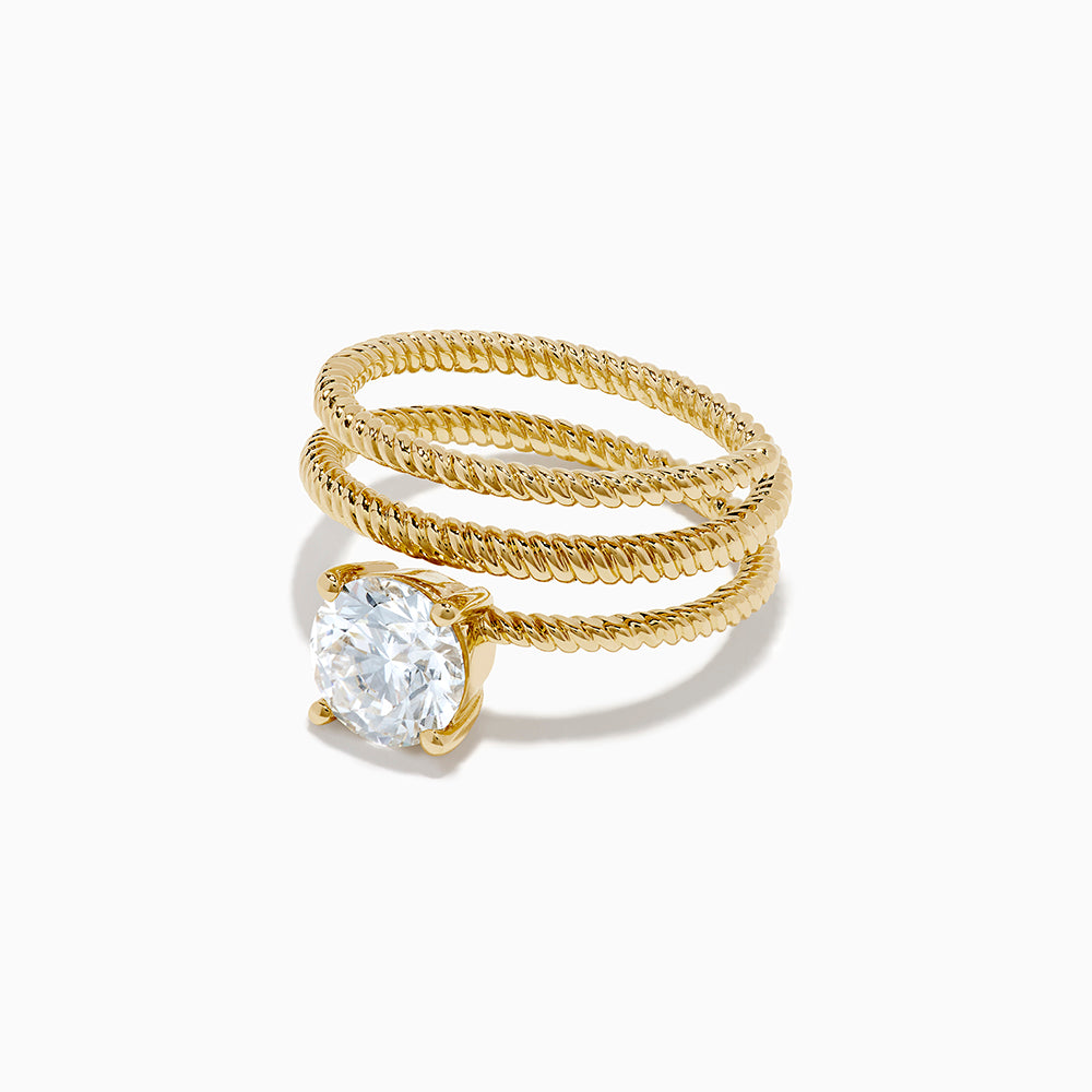 The Lab Grown Diamond Wrap around Round Ring in 14K Yellow Gold features a twisted triple-band design with a large round diamond center, shown against a white background.