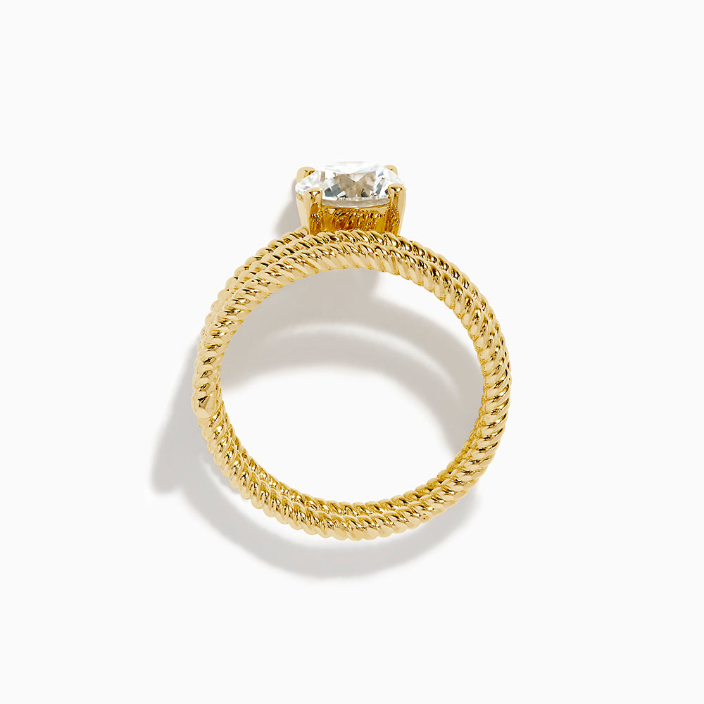 The Lab Grown Diamond Wrap around Round Ring in 14K Yellow Gold features a twisted triple-band design with a large round diamond center, shown against a white background.