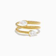 A Lab Grown Diamond Wrap around Toi et Moi Ring in 14K Yellow Gold features an open twisted band with two pear-shaped diamonds at each end, shown on a plain white background.