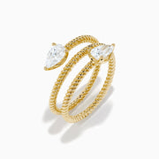 A Lab Grown Diamond Wrap around Toi et Moi Ring in 14K Yellow Gold features an open twisted band with two pear-shaped diamonds at each end, shown on a plain white background.