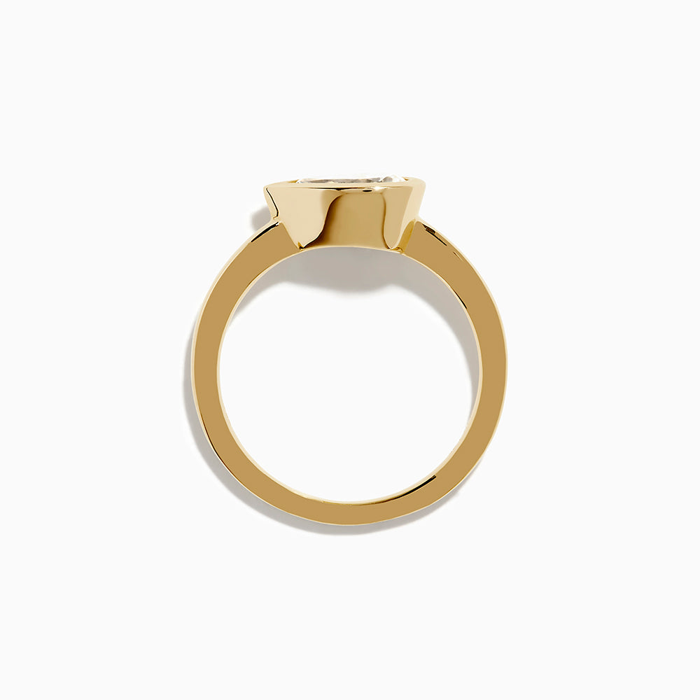 The Lab Grown Diamond East West Pear Ring in 14K Yellow Gold showcases a lab diamond in a pear shape, set horizontally in a sleek bezel on a plain band, presented against a white background.