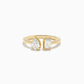The Lab Grown Diamond Toi Et Moi Ring in 14K Yellow Gold features a pear-shaped diamond and an emerald-cut lab diamond set side by side on a plain gold band, displayed on a white background.