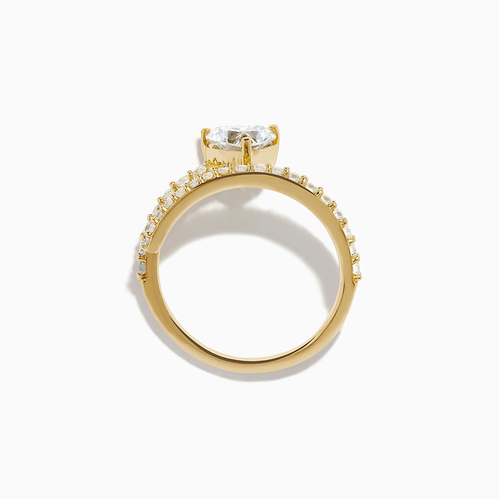 The Lab Grown Diamond Wrap Around Heart Ring in 14K Yellow Gold showcases a heart-shaped center stone and two open bands adorned with diamonds, elegantly displayed on a white background.