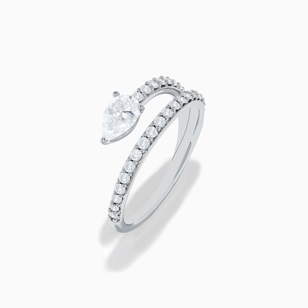 The Lab Grown Diamond Wrap around Pear Ring in 14K White Gold showcases a pear-shaped central diamond and a split shank adorned with lab diamonds, elegantly displayed on a plain white background.