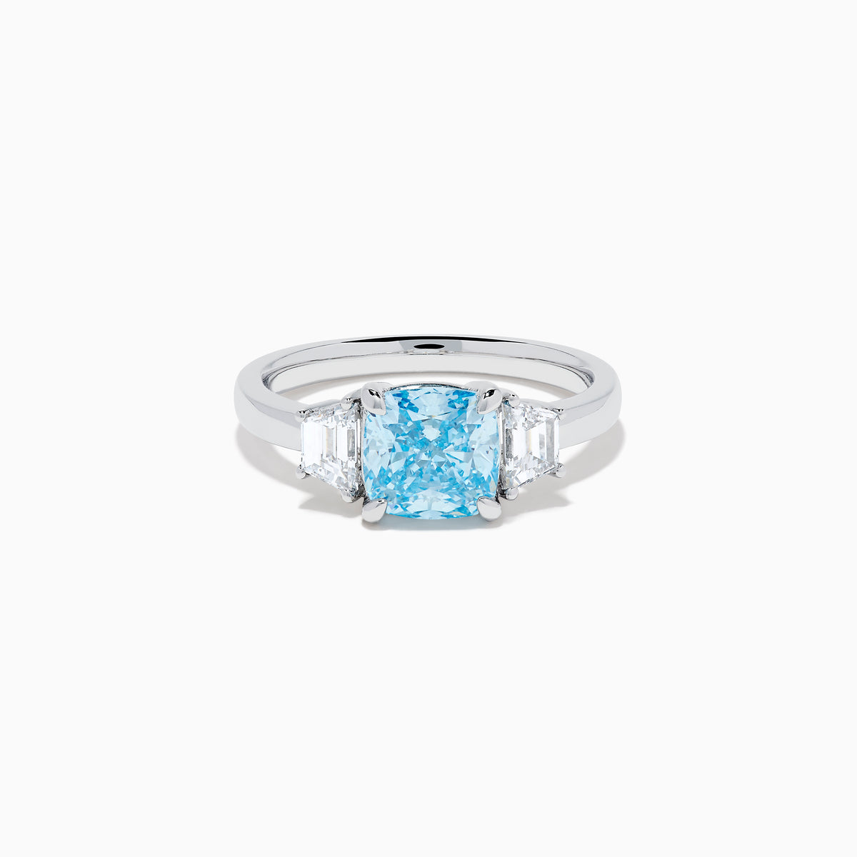 A Lab Grown Blue and White Diamond 3 Stone Ring in 14K White Gold showcases a central rectangular blue diamond flanked by two clear rectangular diamonds, set in gleaming white gold and displayed against a white background.