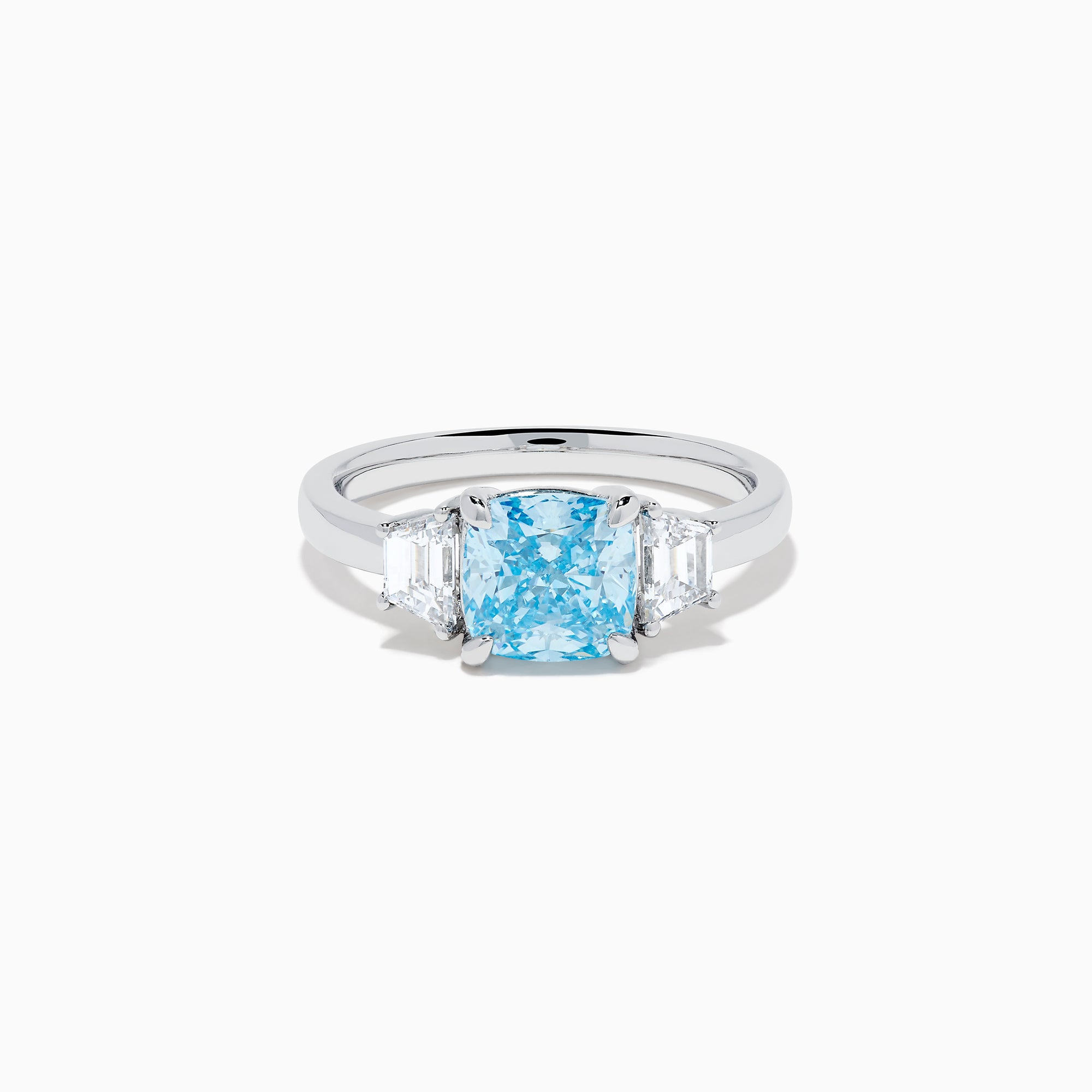 A Lab Grown Blue and White Diamond 3 Stone Ring in 14K White Gold showcases a central rectangular blue diamond flanked by two clear rectangular diamonds, set in gleaming white gold and displayed against a white background.