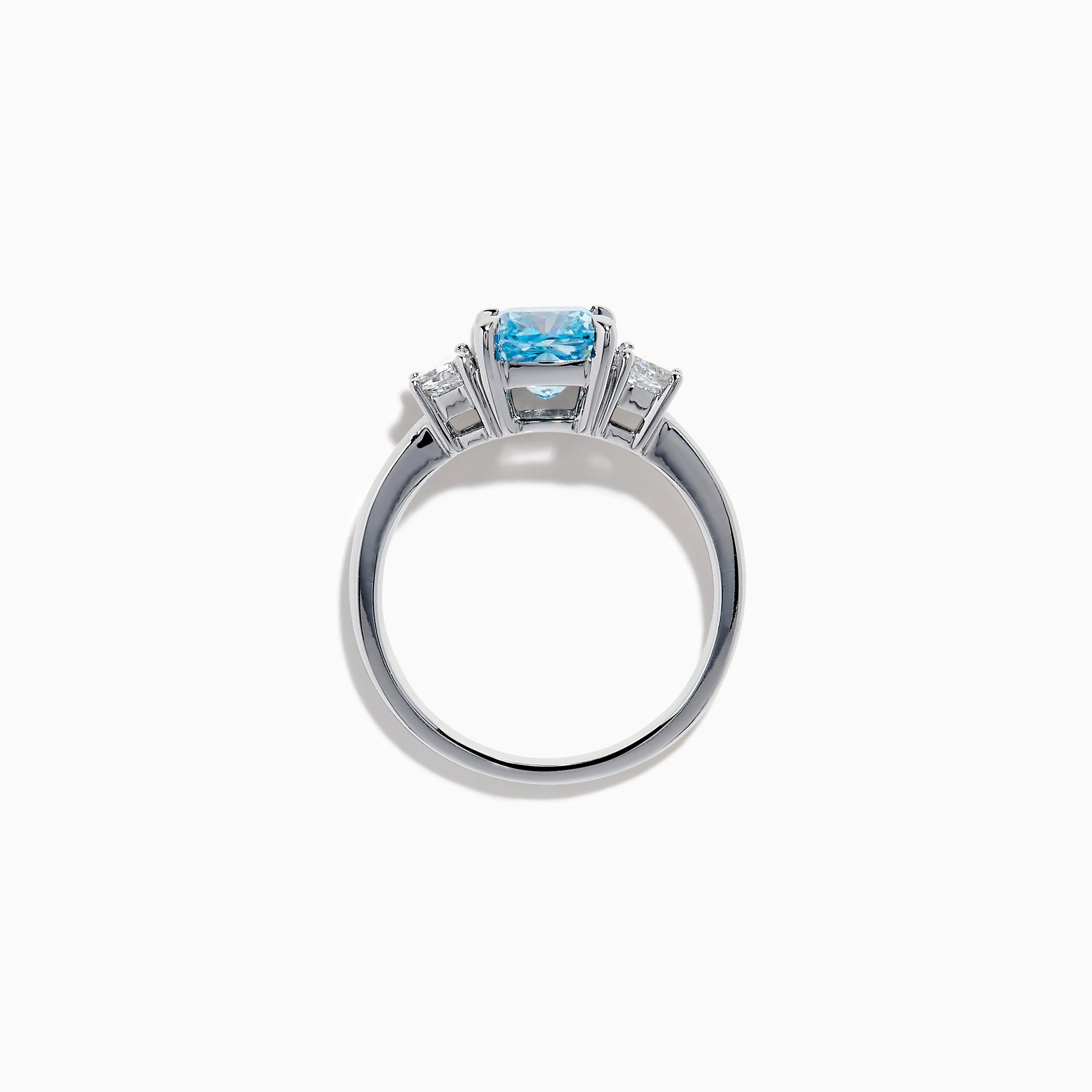 A Lab Grown Blue and White Diamond 3 Stone Ring in 14K White Gold showcases a central rectangular blue diamond flanked by two clear rectangular diamonds, set in gleaming white gold and displayed against a white background.
