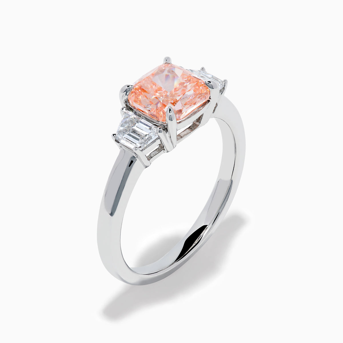 The Lab Grown Pink and White Diamond 3 Stone Ring in 14K White Gold features a rectangular cushion-cut pink center stone with two smaller rectangular white diamonds on each side.