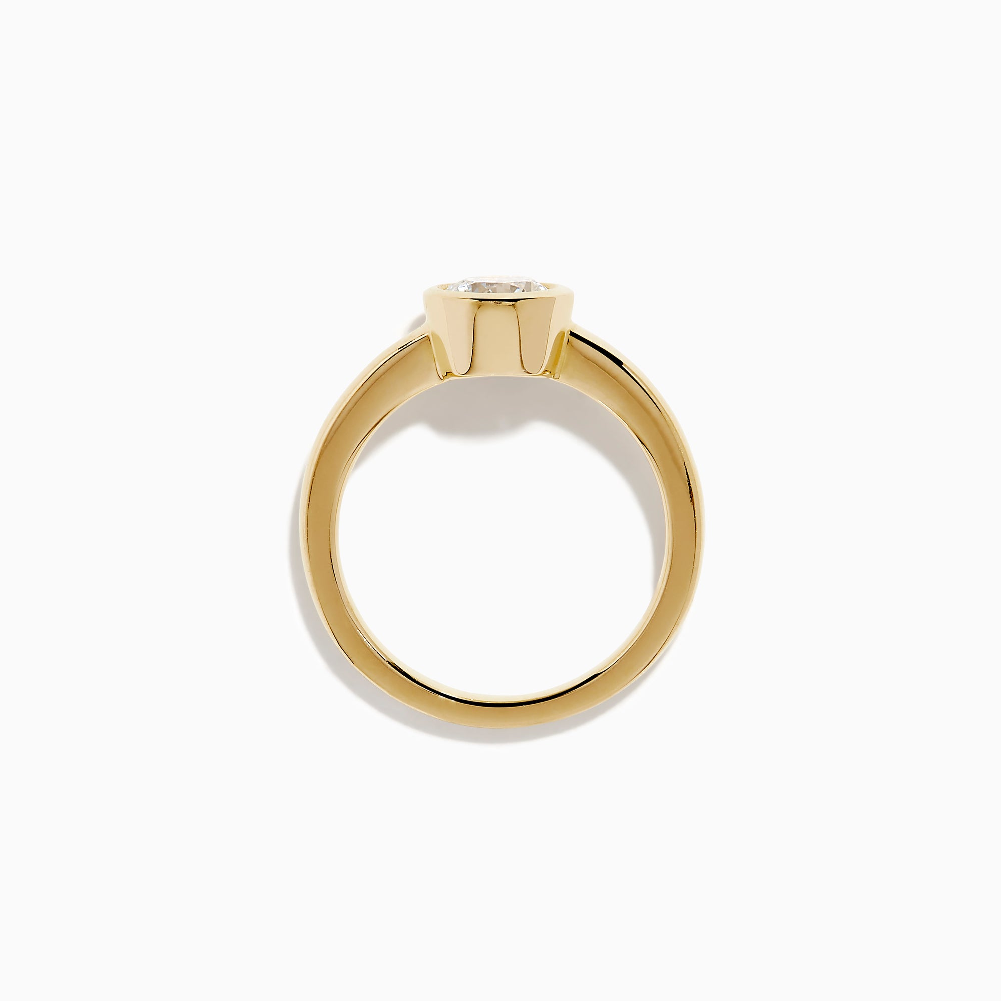 The Lab Grown Round Diamond Bezel Ring in 14K Yellow Gold features a simple band with a single bezel-set round white diamond at the center, shown on a white background.