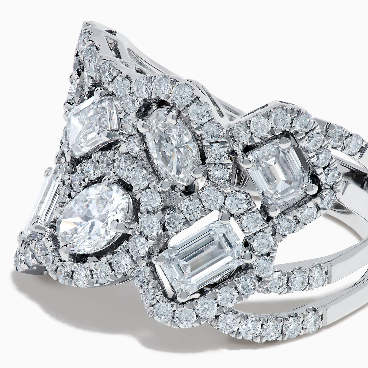 The Lab Grown Multi Shape Diamond Wide Ring in 14K White Gold displays marquise, baguette, and round-cut lab grown diamonds set in an elaborate, interwoven silver design for a sparkling, textured look.