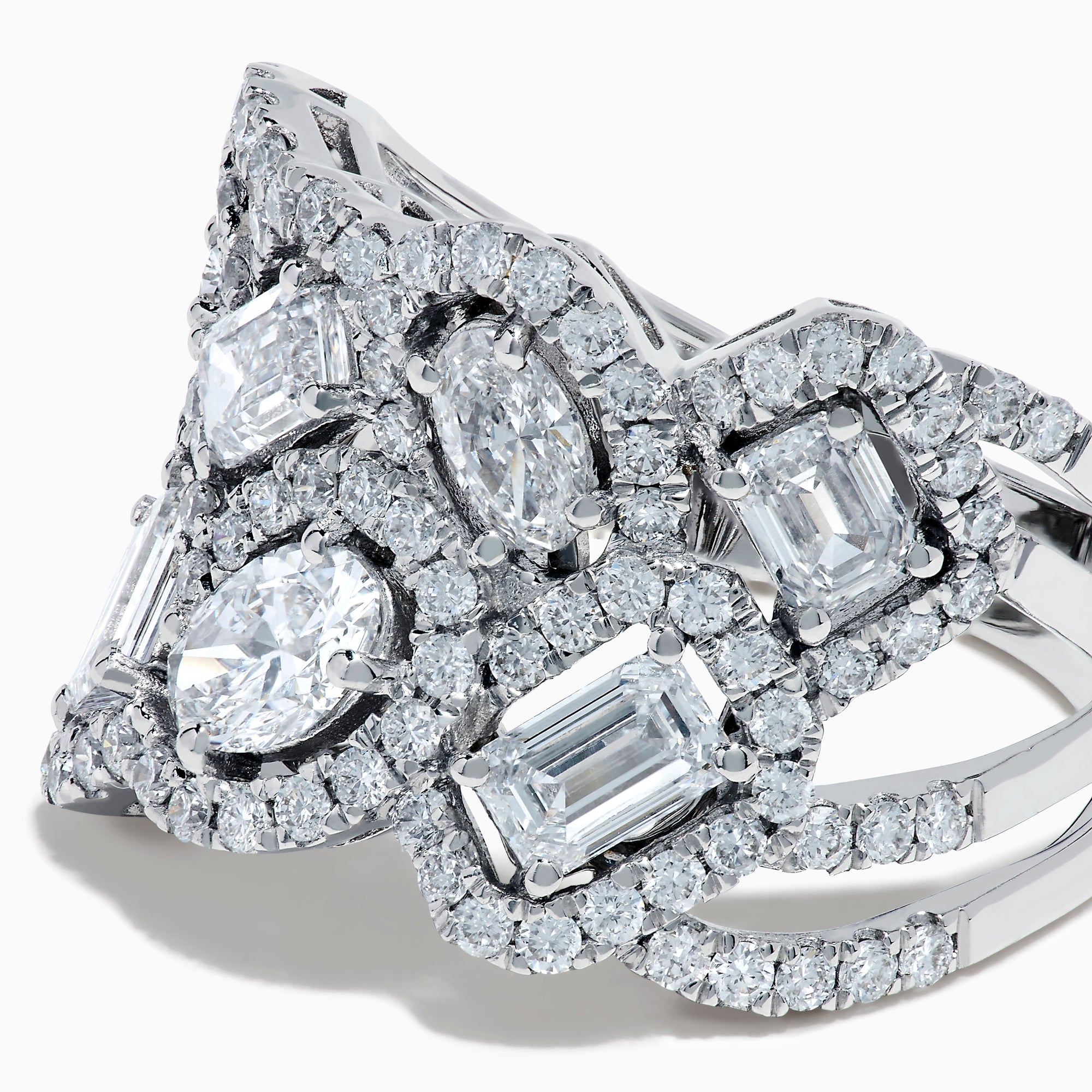 The Lab Grown Multi Shape Diamond Wide Ring in 14K White Gold displays marquise, baguette, and round-cut lab grown diamonds set in an elaborate, interwoven silver design for a sparkling, textured look.